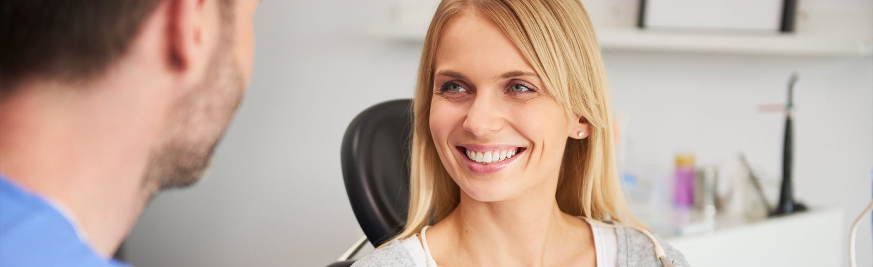 Blonde woman smiling in the dentist's office
