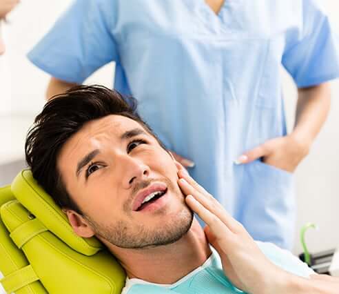 man at dentist in pain