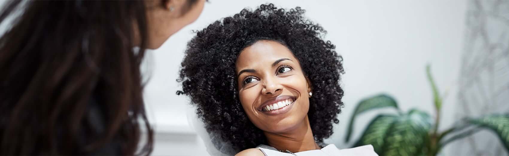 Black woman smiling during her dental visit