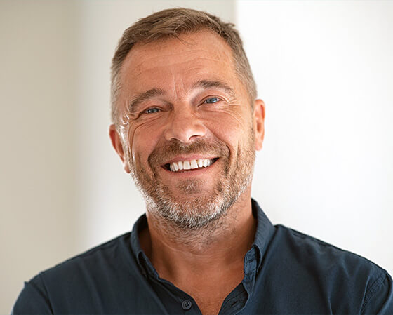 man smiling with dental implants