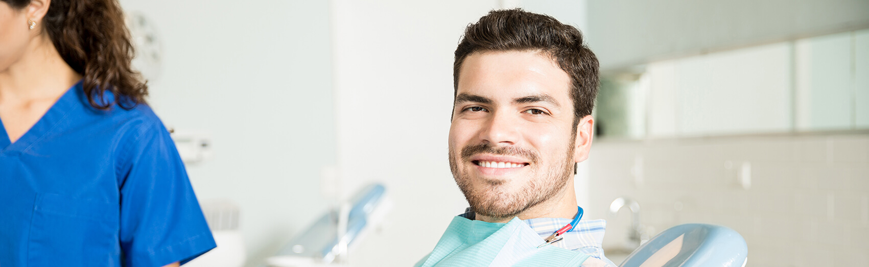 smiling man sitting in a dental chair